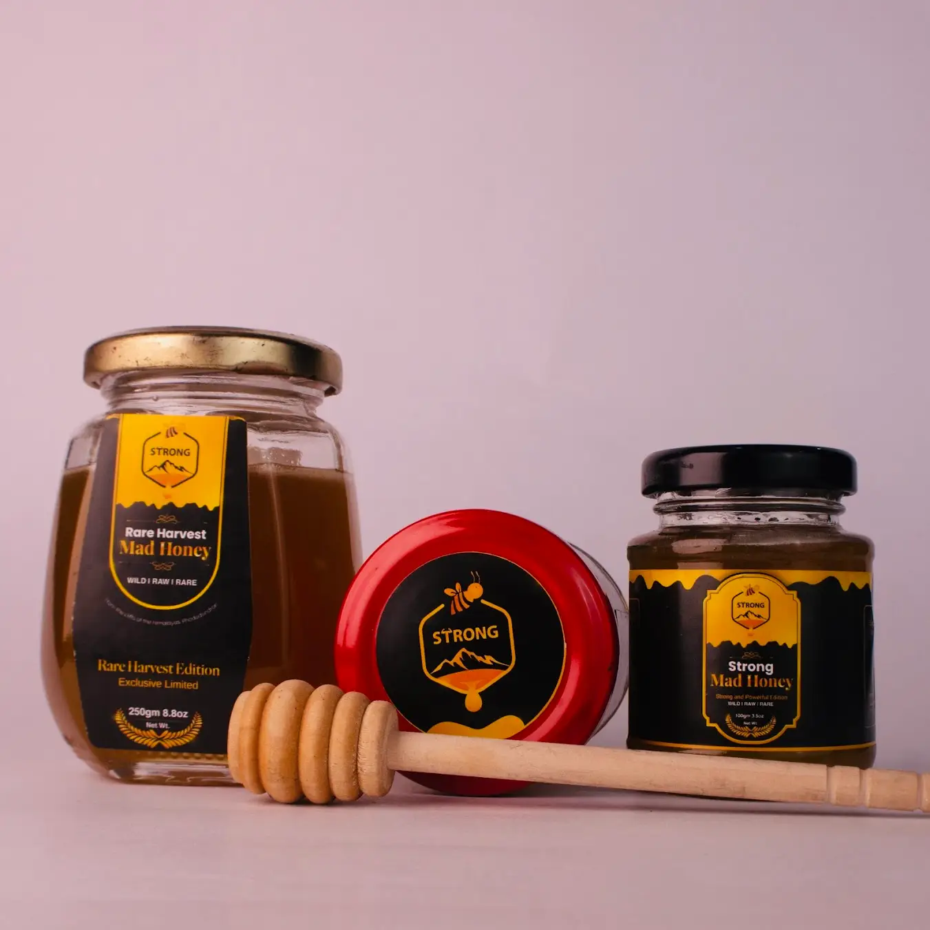 Strong Mad Honey jars — Rare Harvest and Strong Mad Honey, raw wild Himalayan honey with wooden honey dipper